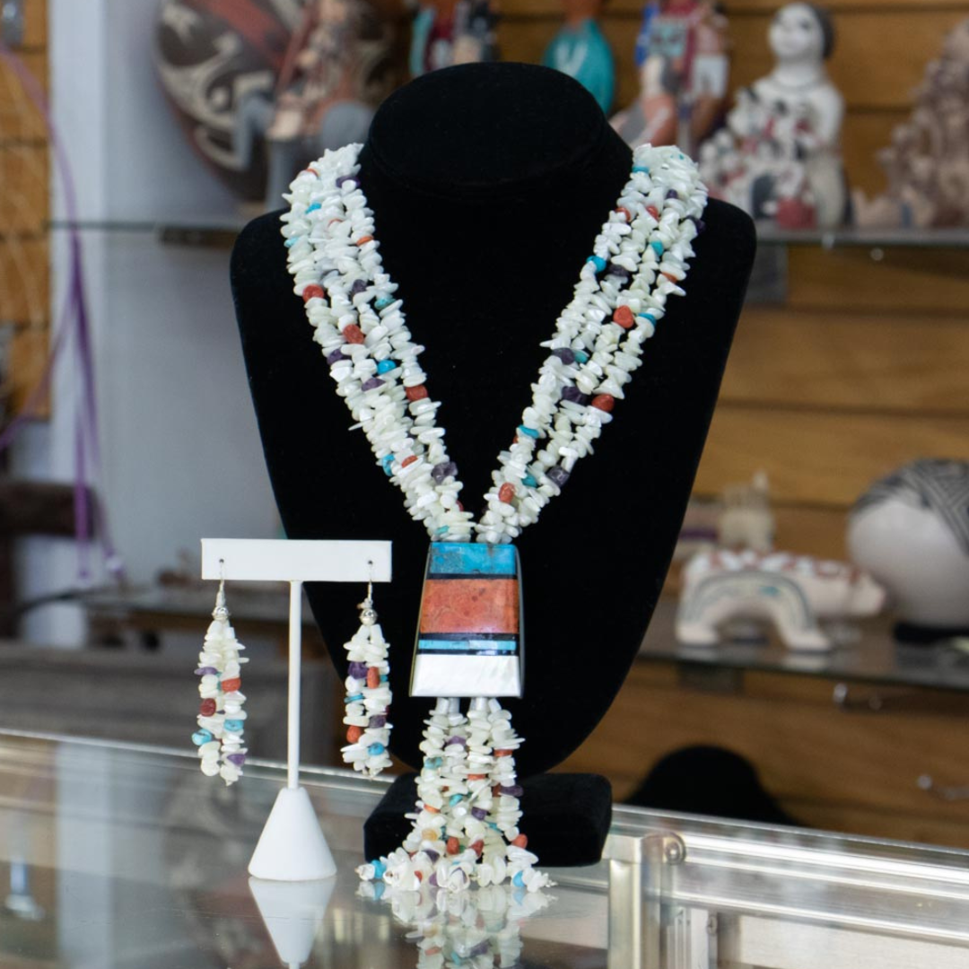 Santa Domingo 4 Strand Beaded Necklace by Torevia Crespin with Mother of Pearl, Amethyst, Apple Coral, Kingman Turq. The inlay center piece has gold lip, mother of pearl, agate and jet.